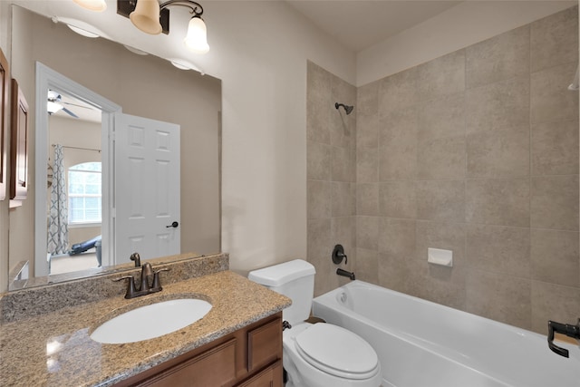 full bathroom with toilet, tiled shower / bath, and vanity