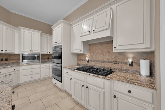 kitchen with ornamental molding, white cabinetry, tasteful backsplash, and stainless steel appliances