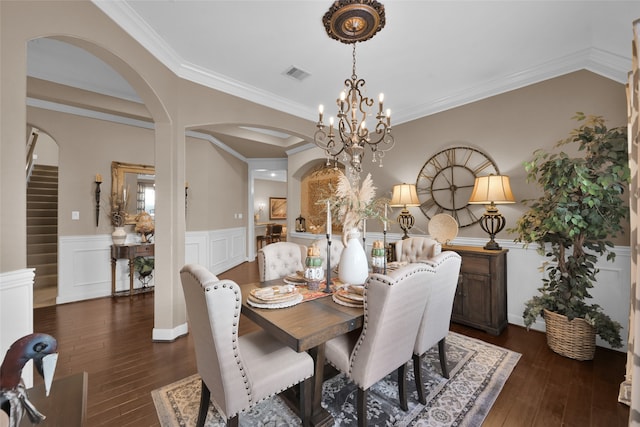 dining area featuring ornamental molding and dark hardwood / wood-style flooring