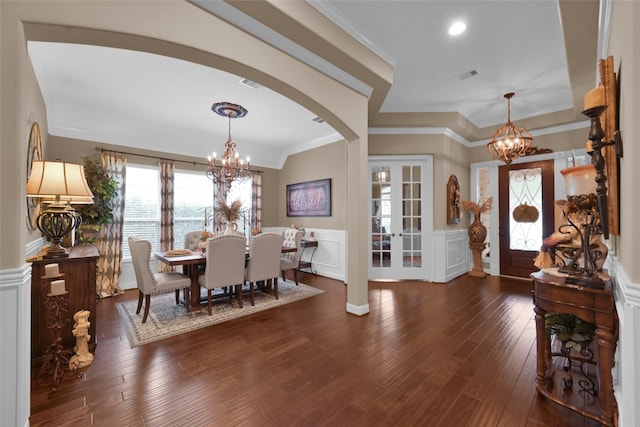 dining space featuring ornamental molding, dark wood-type flooring, and french doors