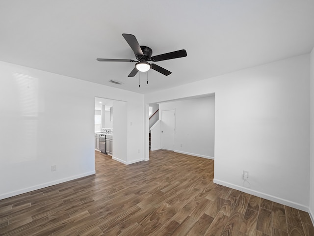 unfurnished living room with ceiling fan and dark hardwood / wood-style flooring