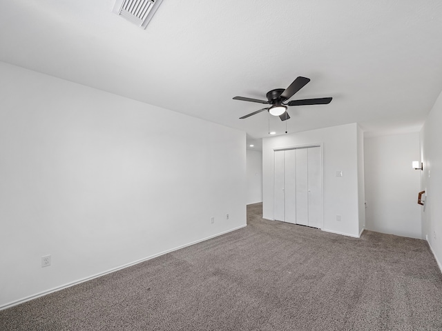 unfurnished bedroom featuring carpet flooring, a closet, and ceiling fan