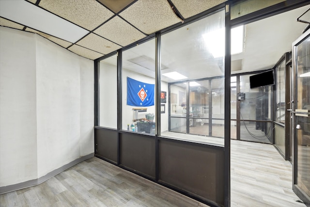 unfurnished room featuring a paneled ceiling and hardwood / wood-style flooring