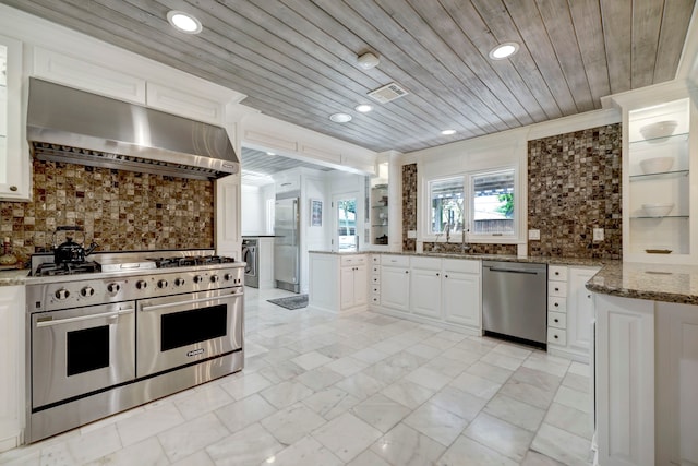 kitchen with backsplash, wood ceiling, stainless steel appliances, white cabinets, and range hood