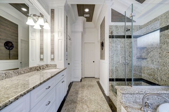 bathroom with vanity, crown molding, and a shower with shower door