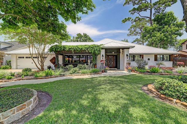 view of front of house with a front lawn and a garage