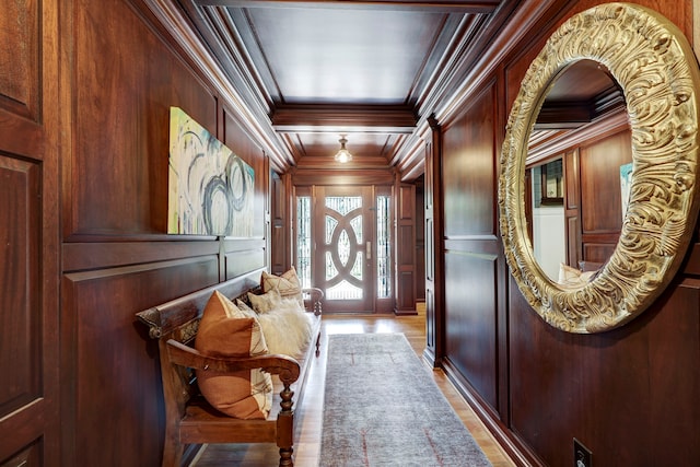 doorway to outside featuring ornamental molding, wooden walls, and hardwood / wood-style flooring