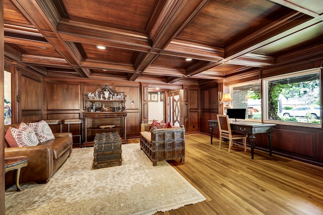 living room featuring beam ceiling, coffered ceiling, wooden walls, and wooden ceiling