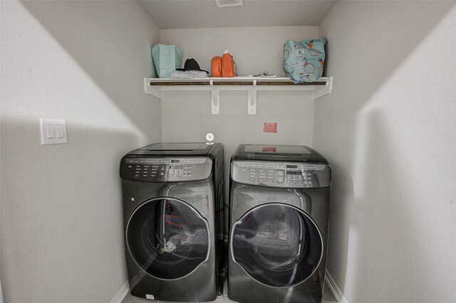 clothes washing area with separate washer and dryer