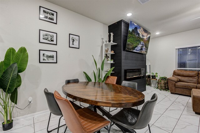 dining room featuring a large fireplace