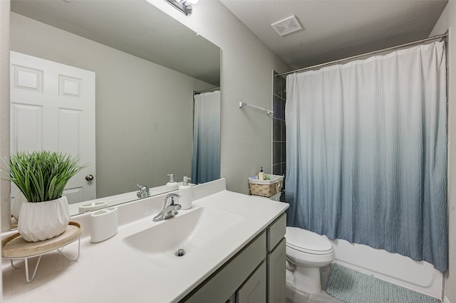 full bathroom featuring vanity, shower / bath combo with shower curtain, toilet, and tile patterned flooring