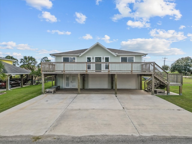 view of front of home with a front yard, a deck, and a garage