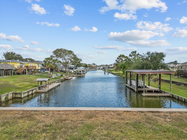 view of dock featuring a yard and a water view