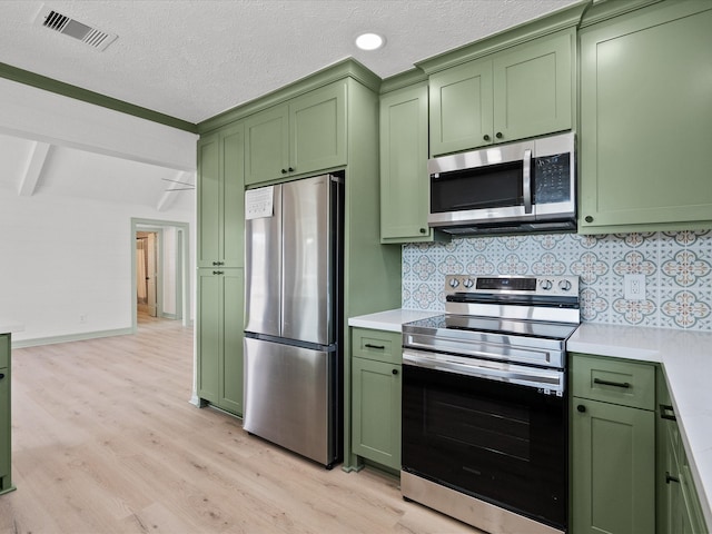 kitchen with light hardwood / wood-style flooring, stainless steel appliances, and green cabinets