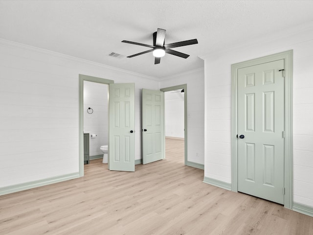 unfurnished bedroom with connected bathroom, crown molding, light wood-type flooring, a textured ceiling, and ceiling fan