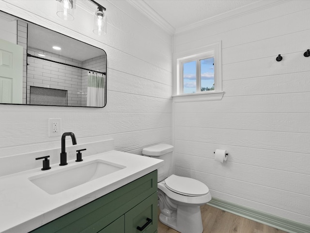 bathroom with toilet, wood-type flooring, ornamental molding, a shower with shower curtain, and vanity