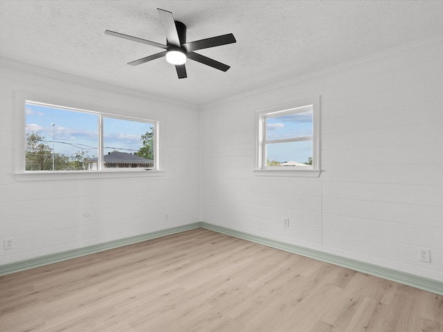 unfurnished room featuring ceiling fan, a textured ceiling, light hardwood / wood-style flooring, and ornamental molding