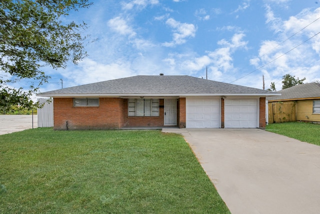 ranch-style house featuring a front yard and a garage