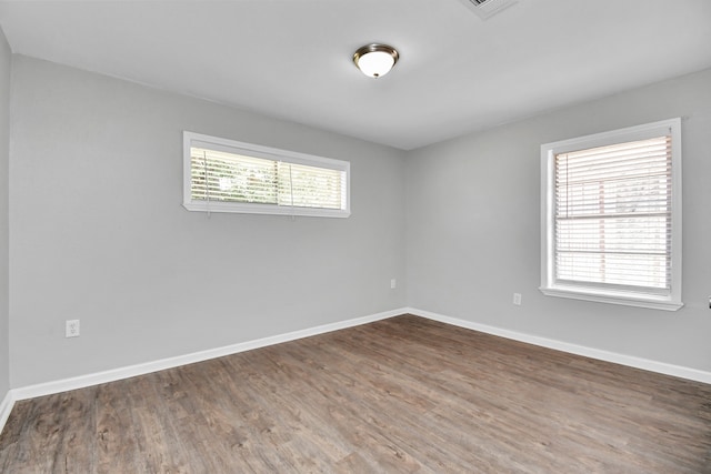 spare room with dark hardwood / wood-style flooring