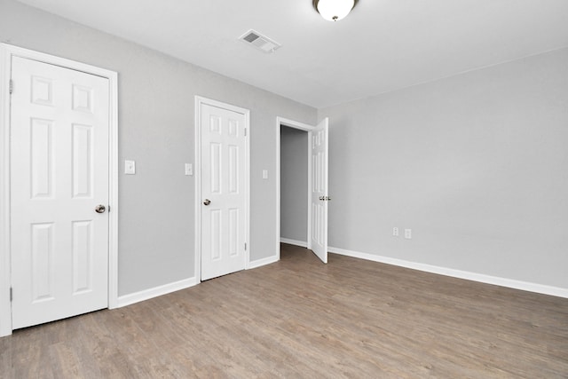 unfurnished bedroom featuring hardwood / wood-style flooring