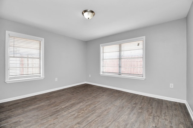 empty room with dark hardwood / wood-style flooring