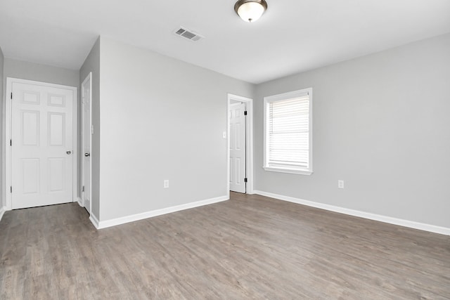 spare room with dark hardwood / wood-style floors