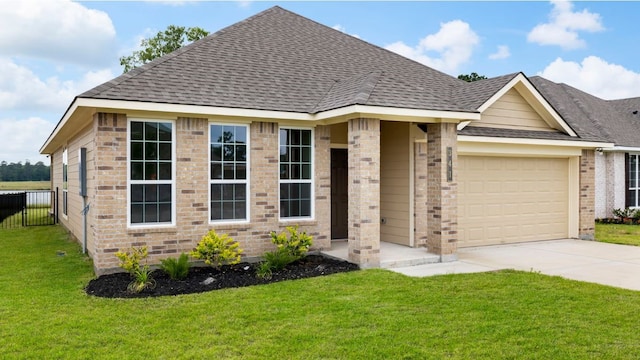 view of front of home with a front lawn and a garage