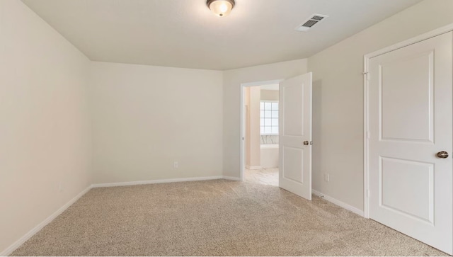 empty room featuring light carpet