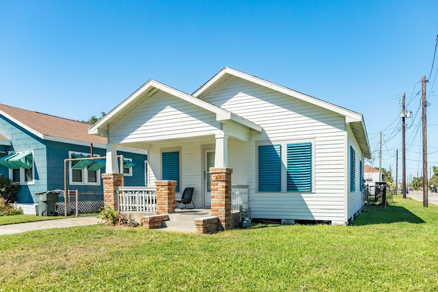 view of front of home featuring a front yard and a porch