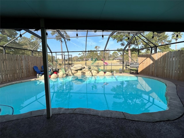 view of swimming pool with a lanai