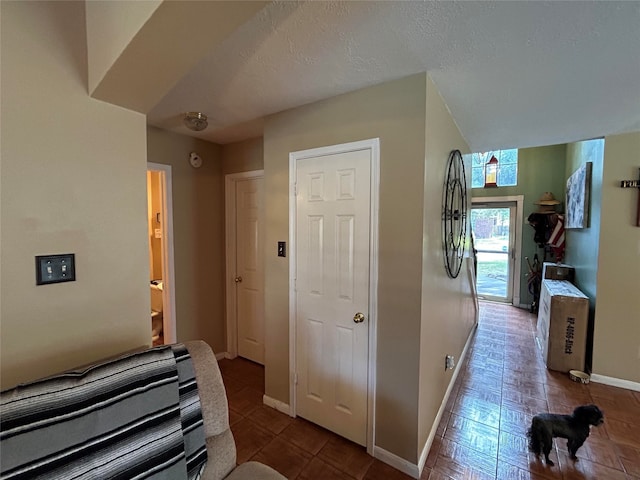 hallway featuring a textured ceiling