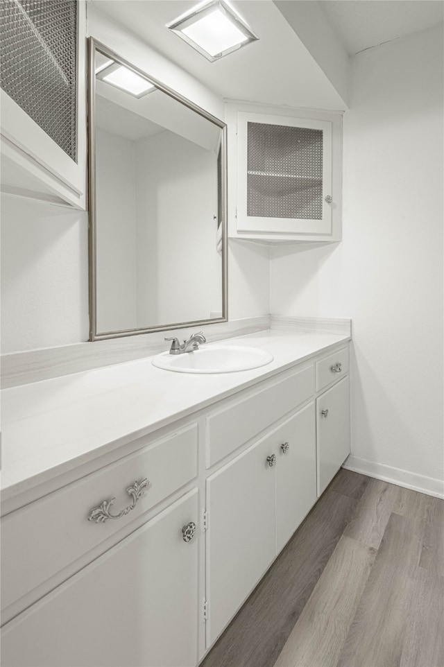 bathroom with vanity and wood-type flooring