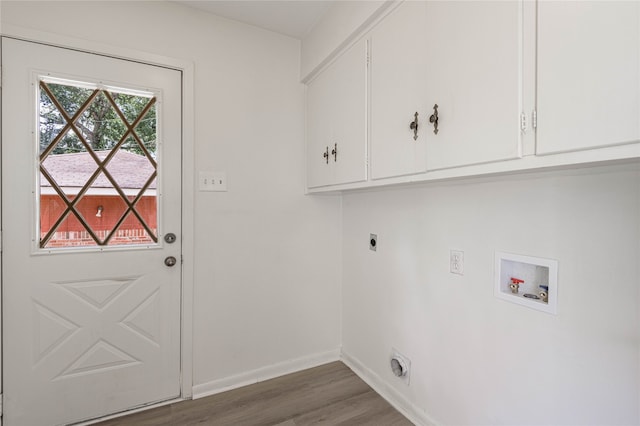 washroom with cabinets, hookup for an electric dryer, dark hardwood / wood-style floors, and hookup for a washing machine