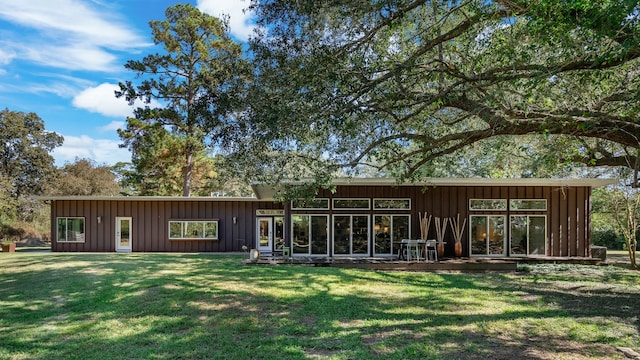 back of house with a yard