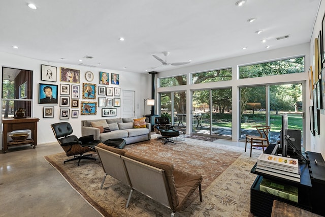 living room featuring a wealth of natural light and ceiling fan