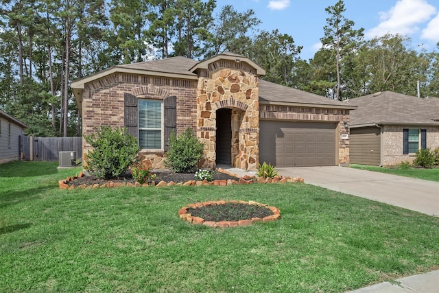 view of front facade featuring central AC, a front yard, and a garage