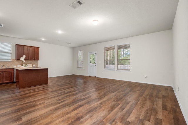 unfurnished living room featuring dark hardwood / wood-style floors