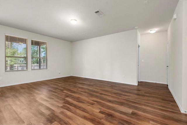 empty room with dark wood-type flooring