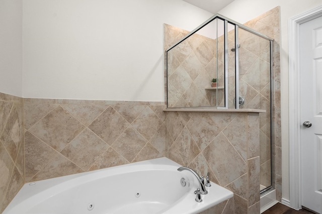 bathroom featuring shower with separate bathtub