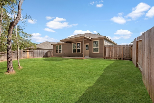 rear view of house featuring a yard