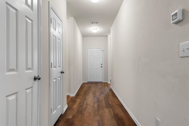 hallway featuring dark hardwood / wood-style flooring