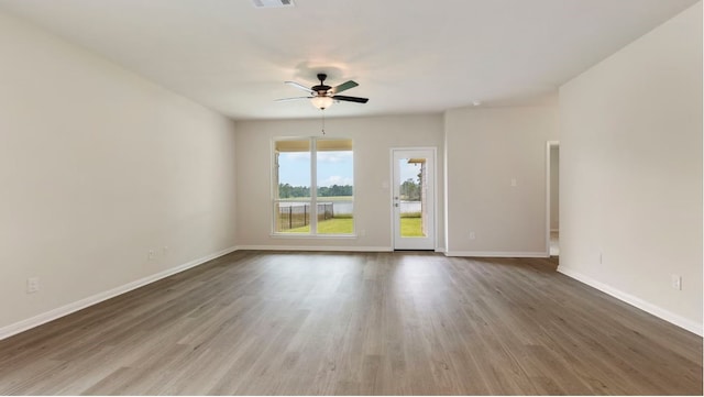 spare room featuring hardwood / wood-style floors and ceiling fan