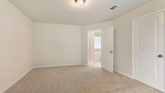 spare room with light colored carpet