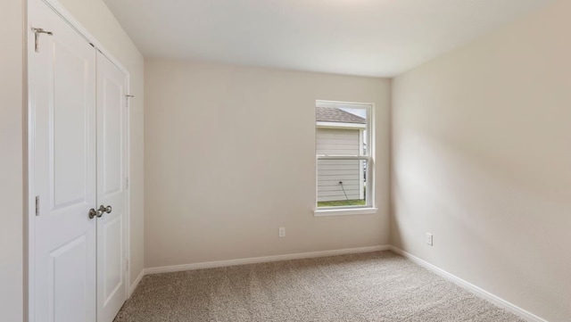 unfurnished bedroom with carpet flooring and a closet