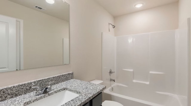 full bathroom with vanity, tub / shower combination, and toilet