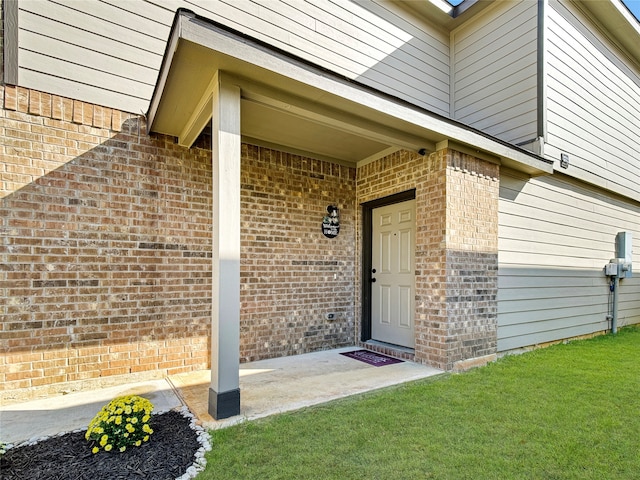 doorway to property with a lawn