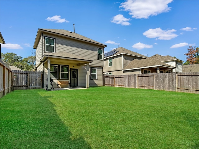 back of property featuring a patio and a lawn