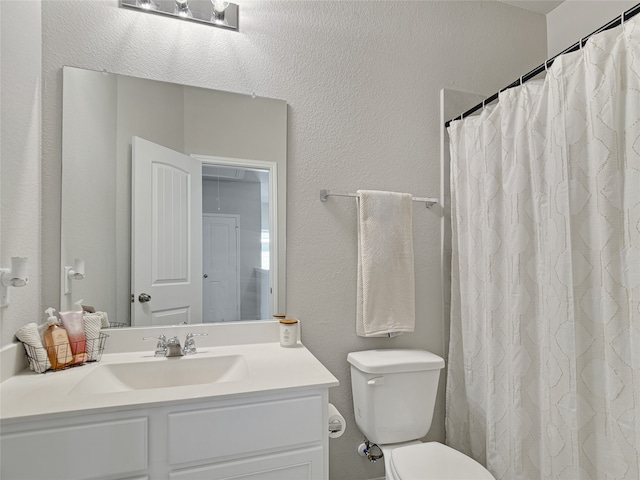 bathroom featuring vanity, toilet, and a shower with curtain