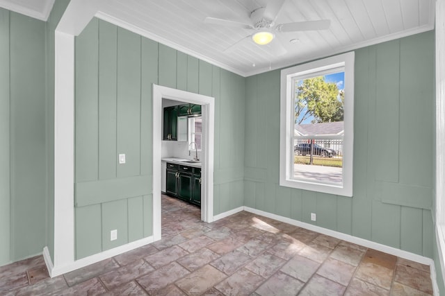 unfurnished room with sink, ornamental molding, and ceiling fan