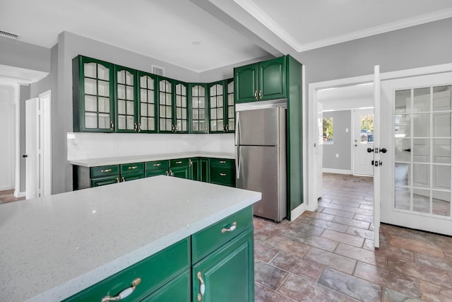 kitchen featuring french doors, crown molding, stainless steel refrigerator, and green cabinetry